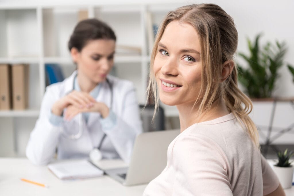 Beautiful female patient smiling in doctor's office