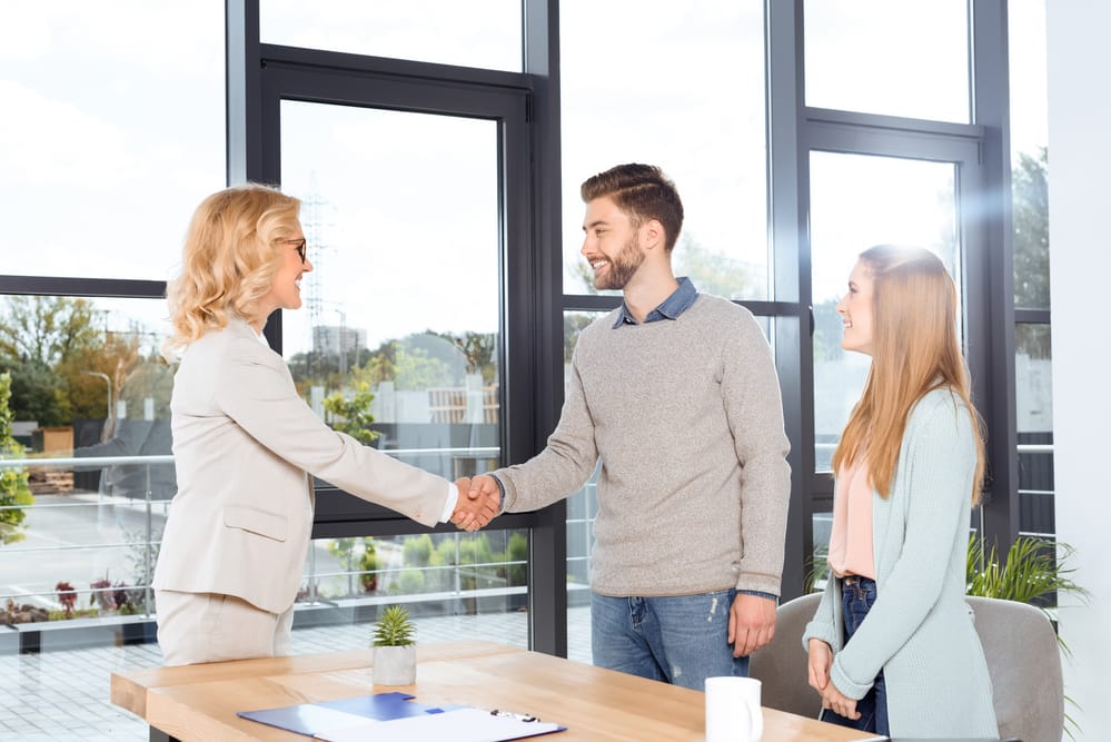 Doctor shaking returning clients hand