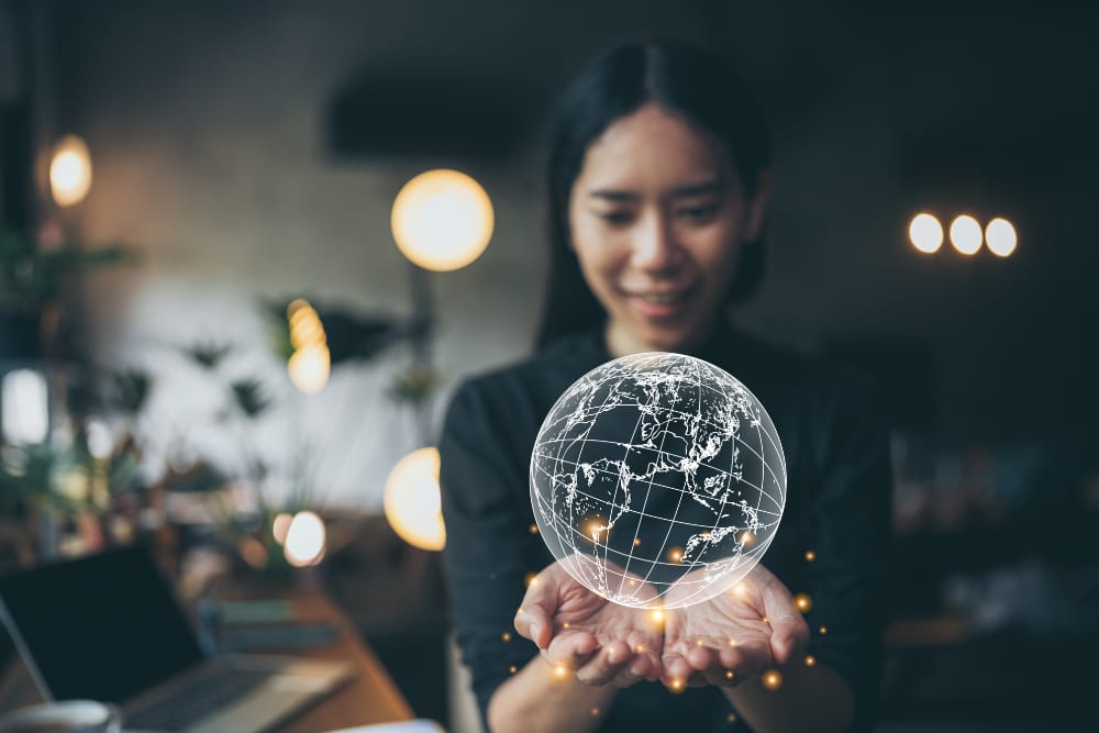 Woman reaching out to hold globe